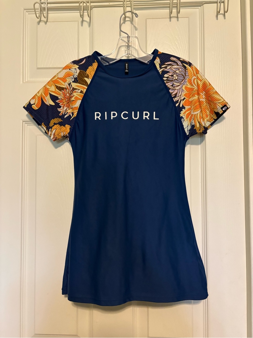 EUC Rip Curl Navy Short-Sleeve Rash Guard with Floral Orange Sleeves.